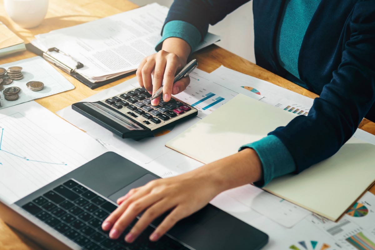 Close up of female accountant or banker making calculations